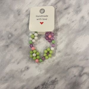 Kid’s size, green, pink and white bracelet.